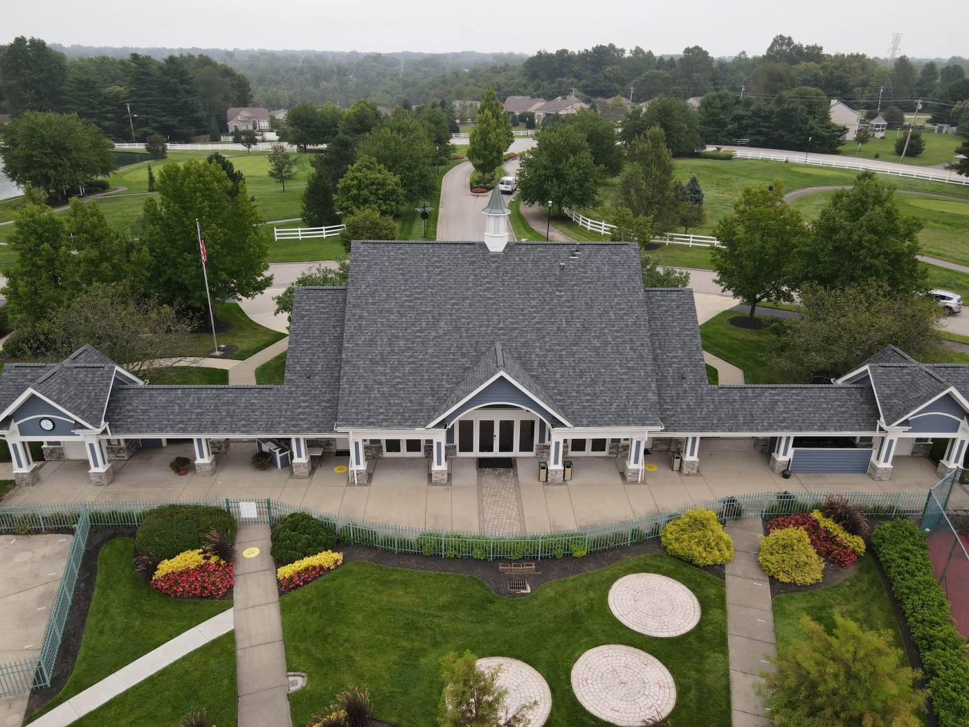 A drone view of a country club building with new roof shingles
