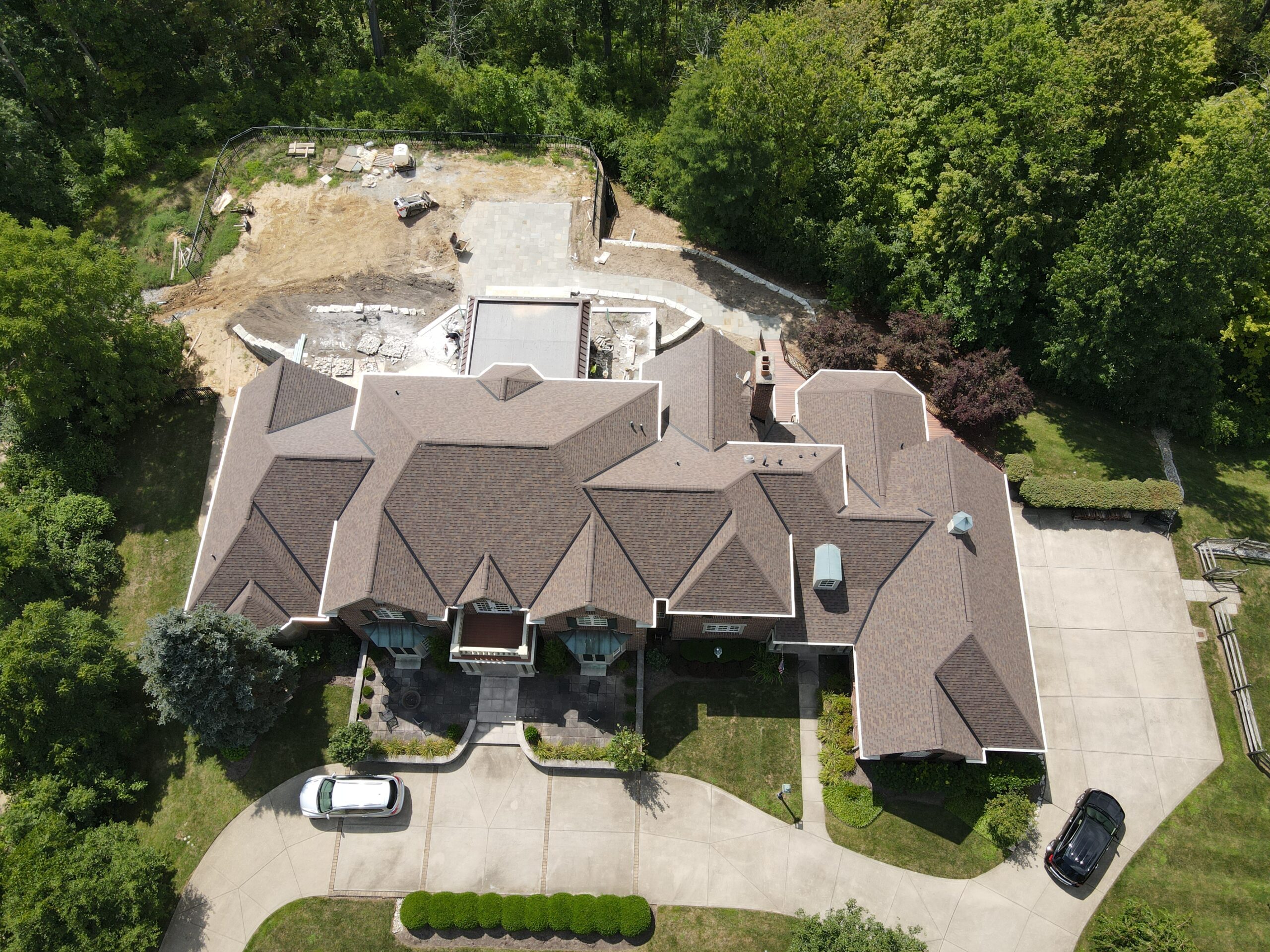 An aerial view of a large home's new roofing shingles from Coldstream Exteriors