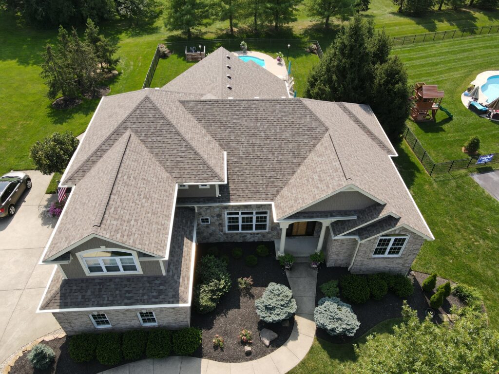 A bird's-eye view of a home with brand new roof shingles