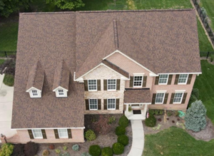 A bird's-eye view of a modern home with brand new roof shingles
